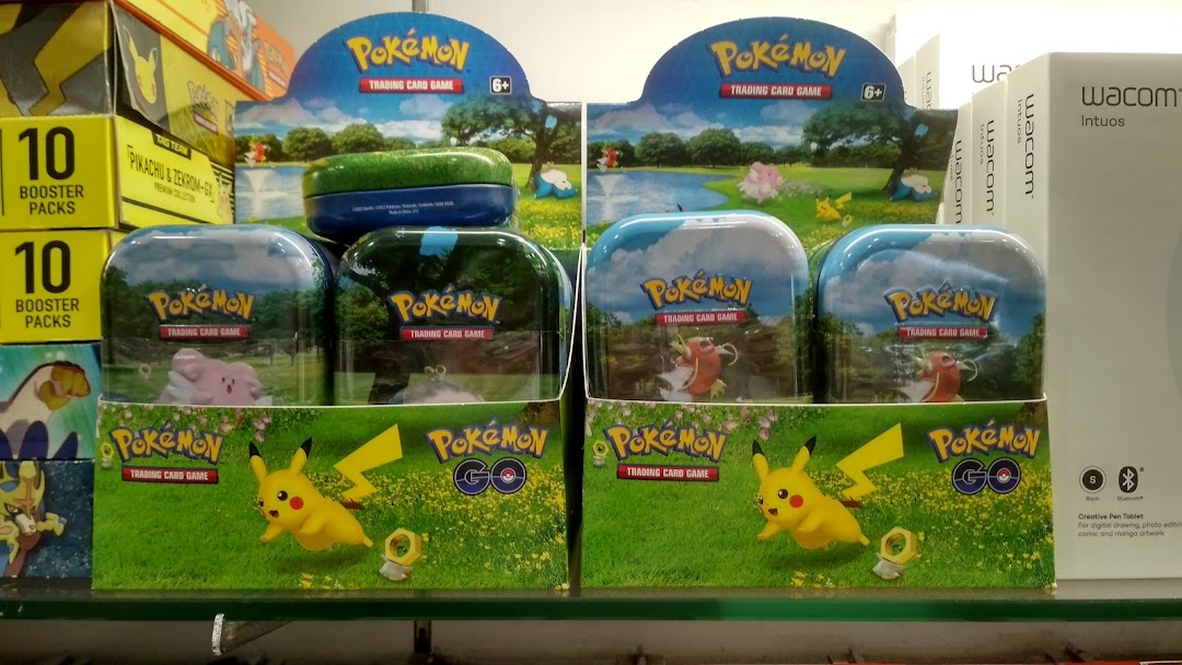 A display of Pokémon Trading Card Game products and Wacom Intuos tablets inside a retail store.