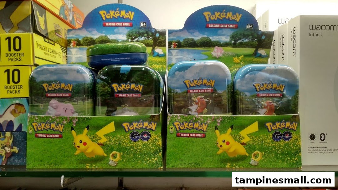 A display of Pokémon Trading Card Game products and Wacom Intuos tablets inside a retail store.