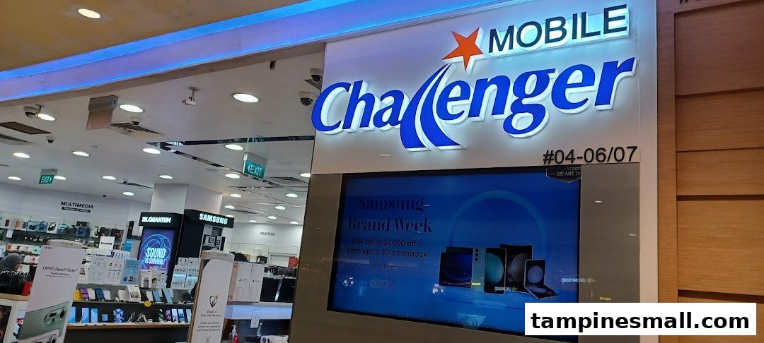 The brightly lit entrance of Challenger electronics store, featuring a large digital display with promotions.