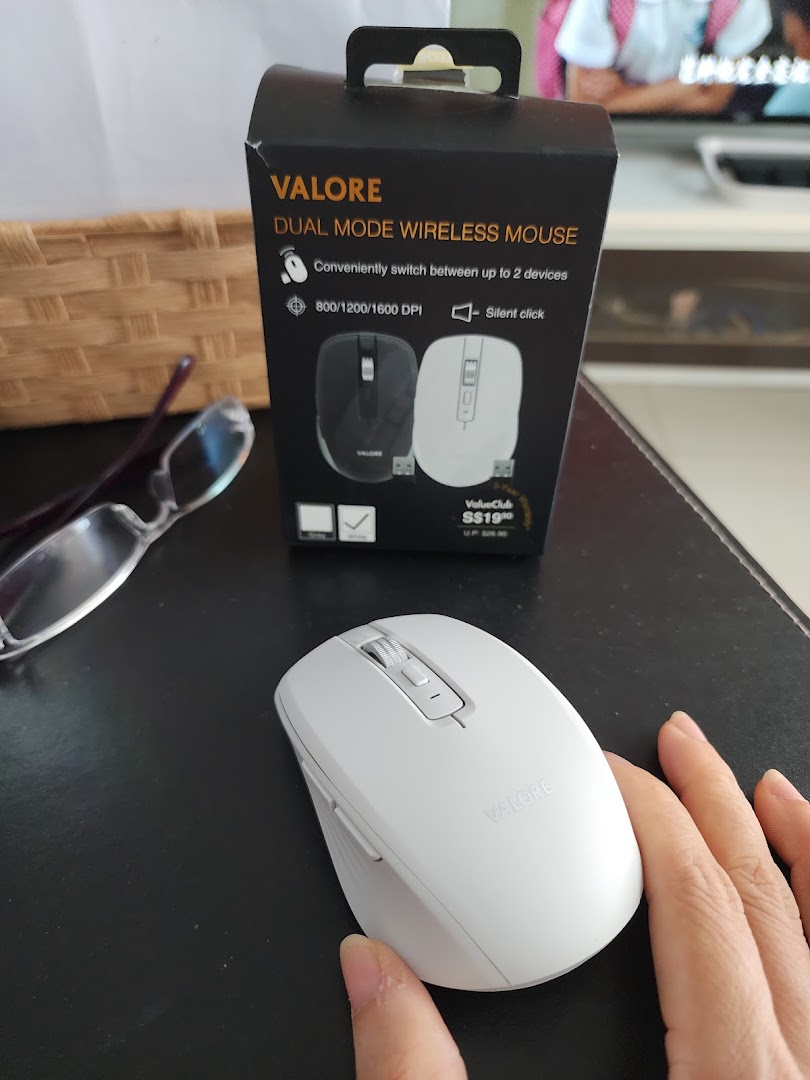 A white Valore dual mode wireless mouse and its packaging box on a dark surface.