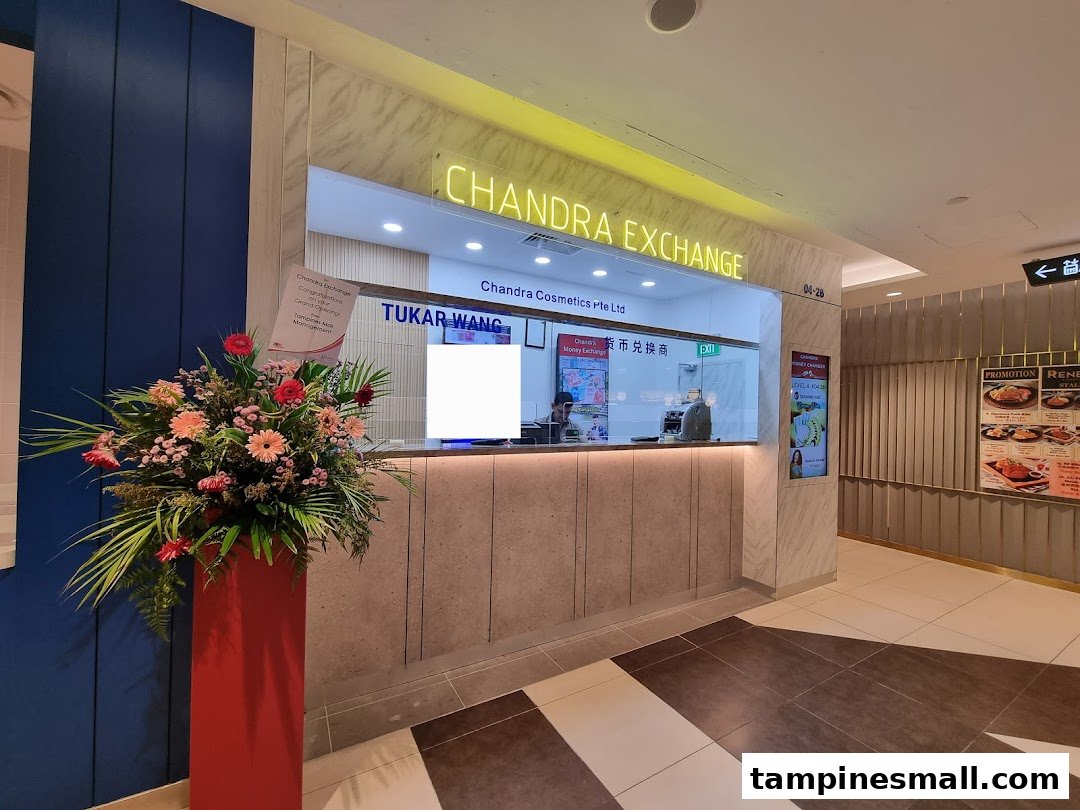 The modern counter of Chandra Money Exchange, featuring a grand opening floral display.