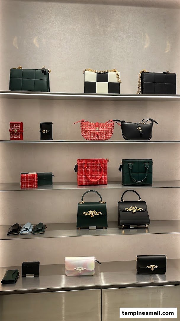 A display of stylish handbags and wallets on multiple shelves inside a retail store.
