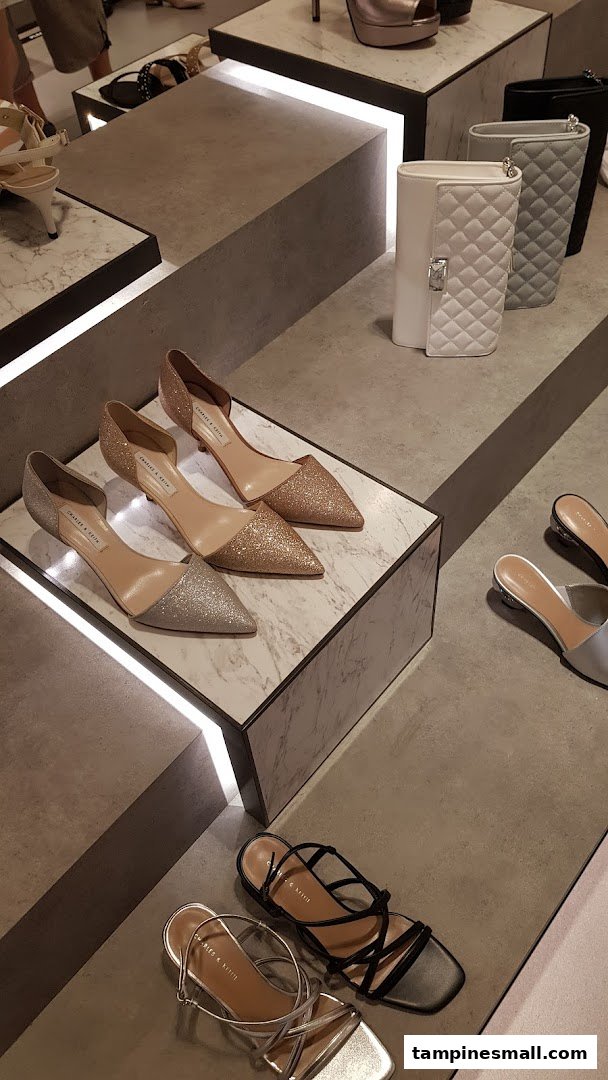 A stylish display of CHARLES & KEITH shoes and handbags in a modern retail setting.