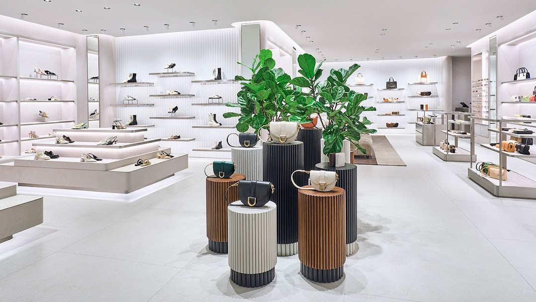 Bright, modern CHARLES & KEITH store interior showcasing stylish shoes and handbags on elegant displays.