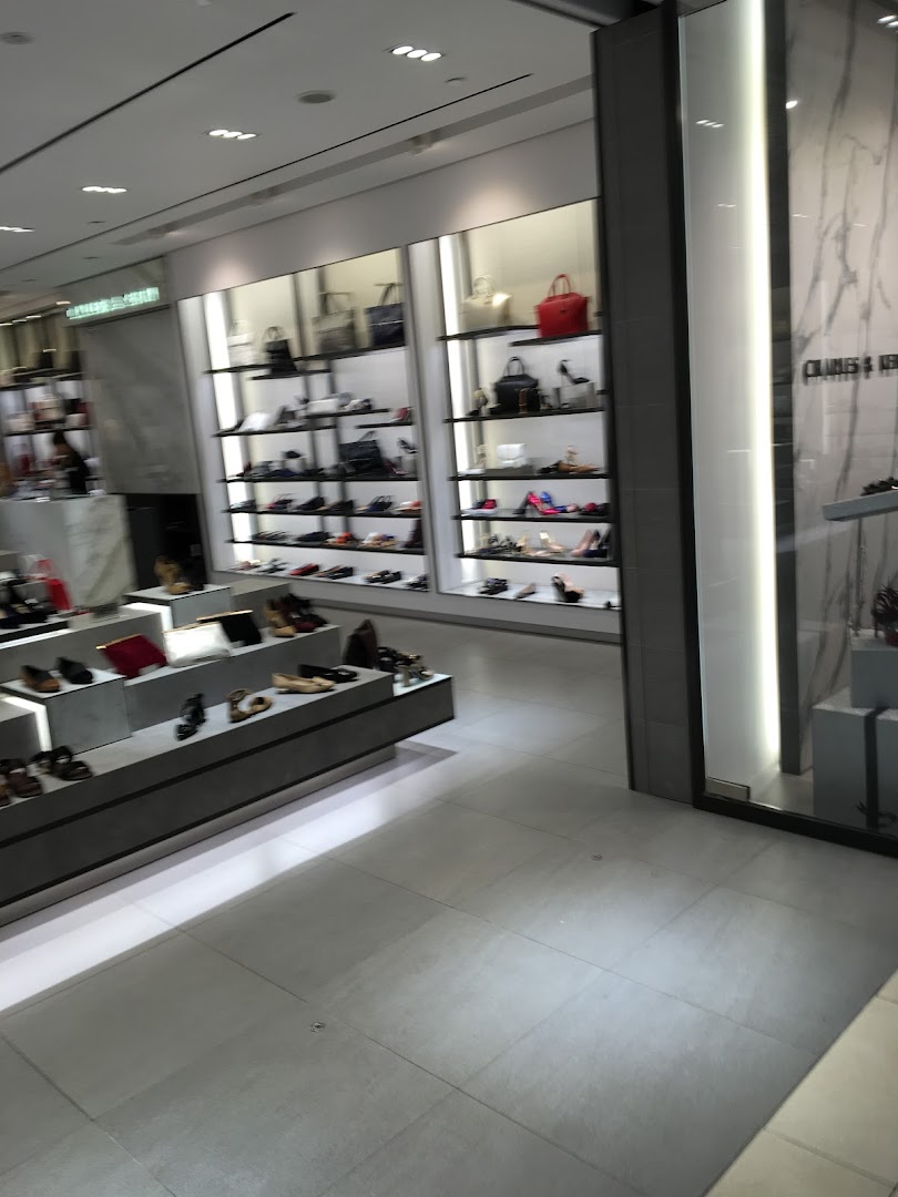 Interior view of CHARLES & KEITH store showcasing a wide array of stylish shoes and handbags on modern displays.