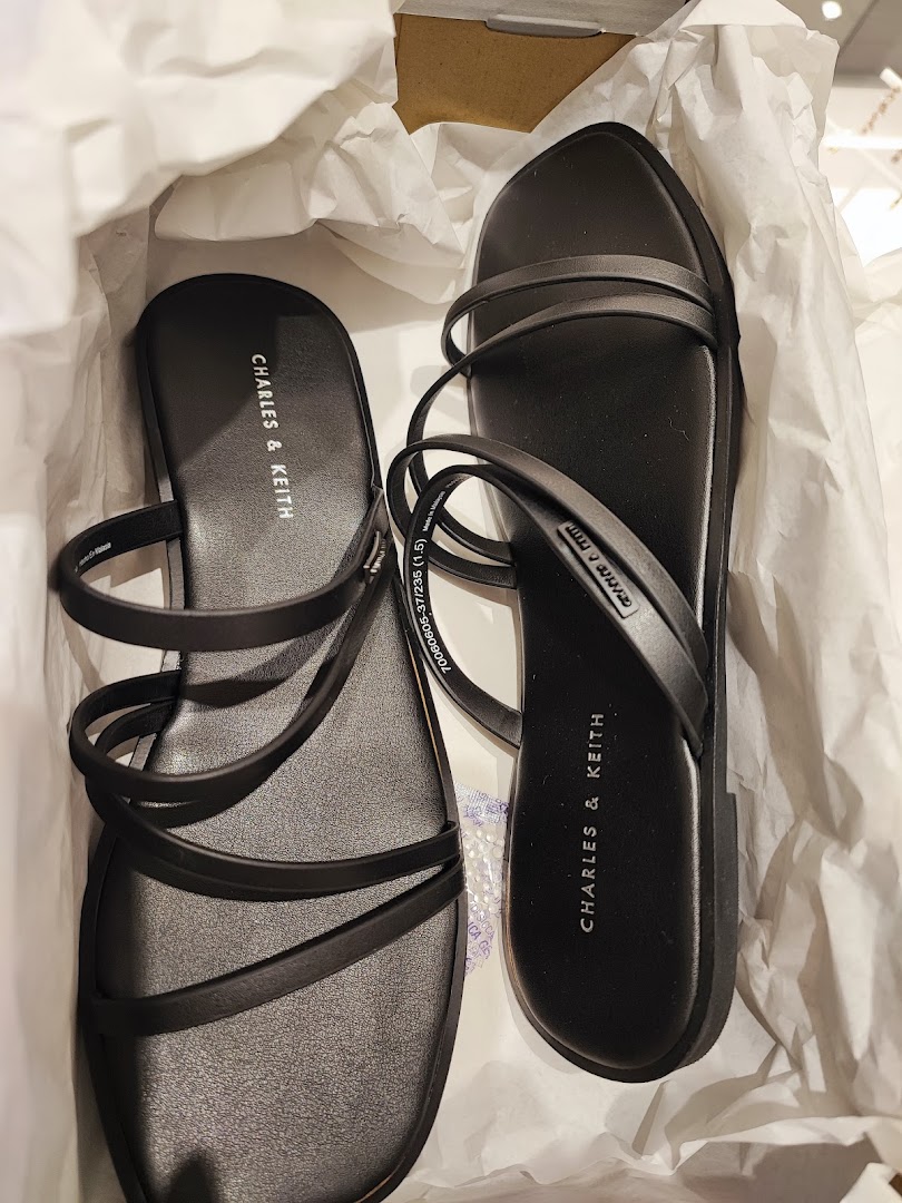 A pair of new black CHARLES & KEITH sandals neatly placed in their box.