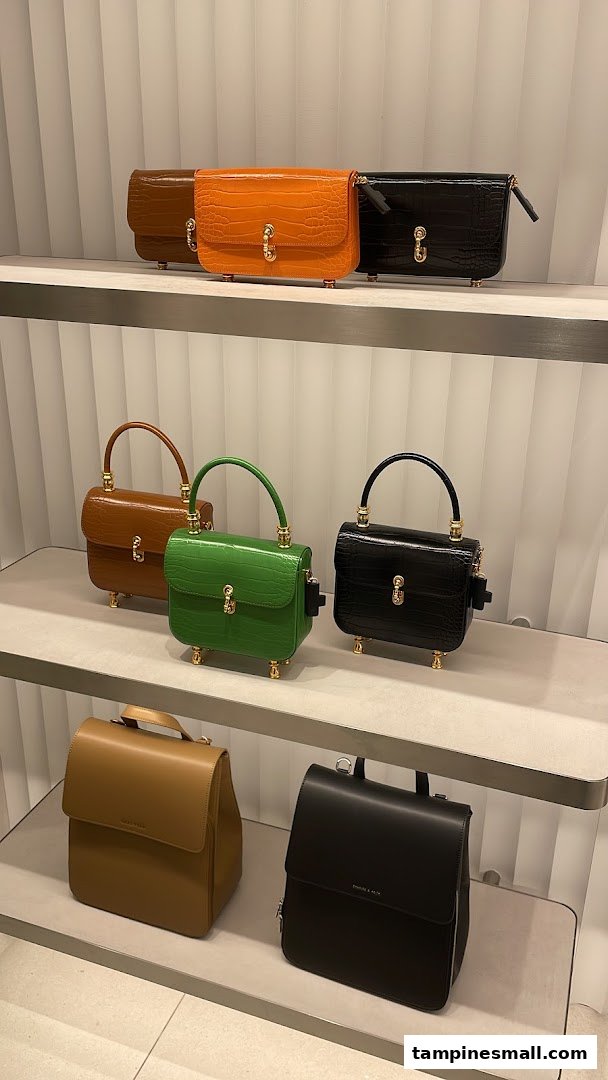 Stylish handbags and backpacks from CHARLES & KEITH displayed on shelves.