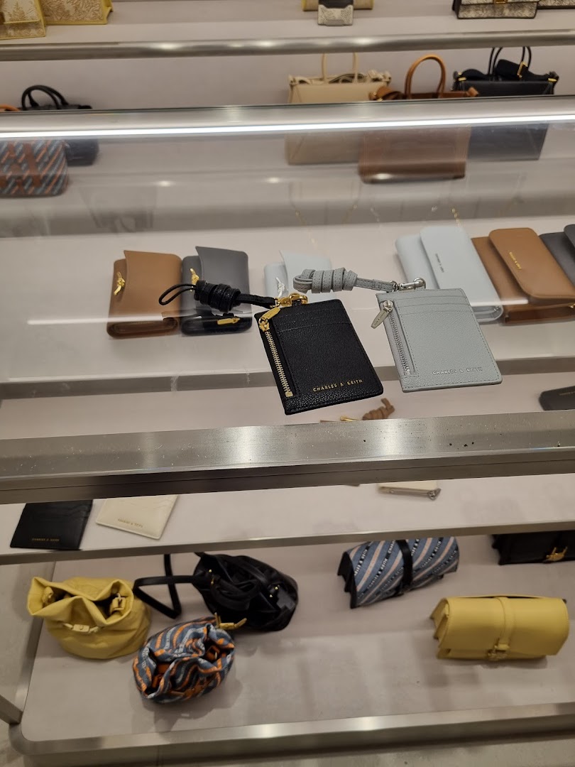 A display of stylish wallets and small bags in various colors and designs from CHARLES & KEITH.