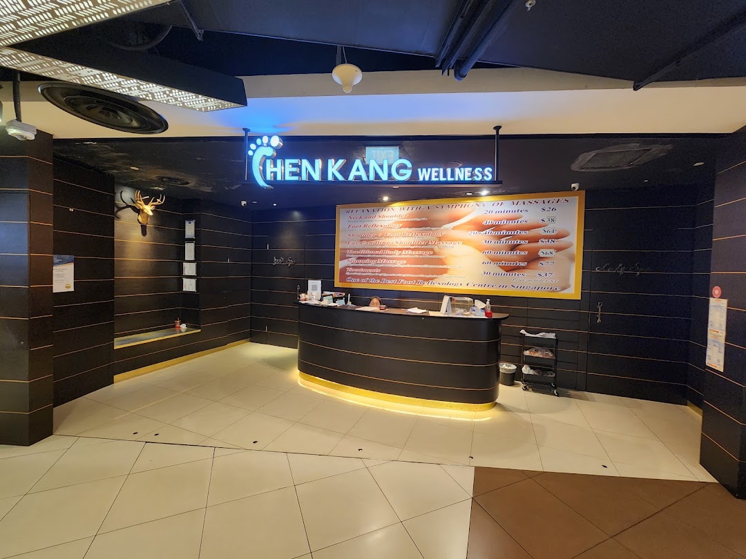 A prominent display of massage and wellness service prices at Chen Kang Wellness.