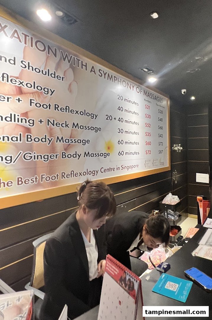 A large price list for various massage and reflexology services at Chen Kang Wellness, with staff at the counter.