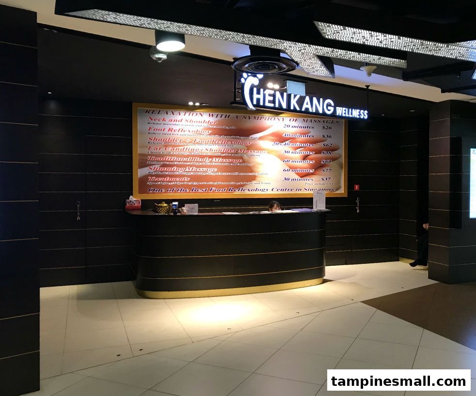 Reception area of Chen Kang Wellness featuring a large sign with massage and reflexology services and prices.