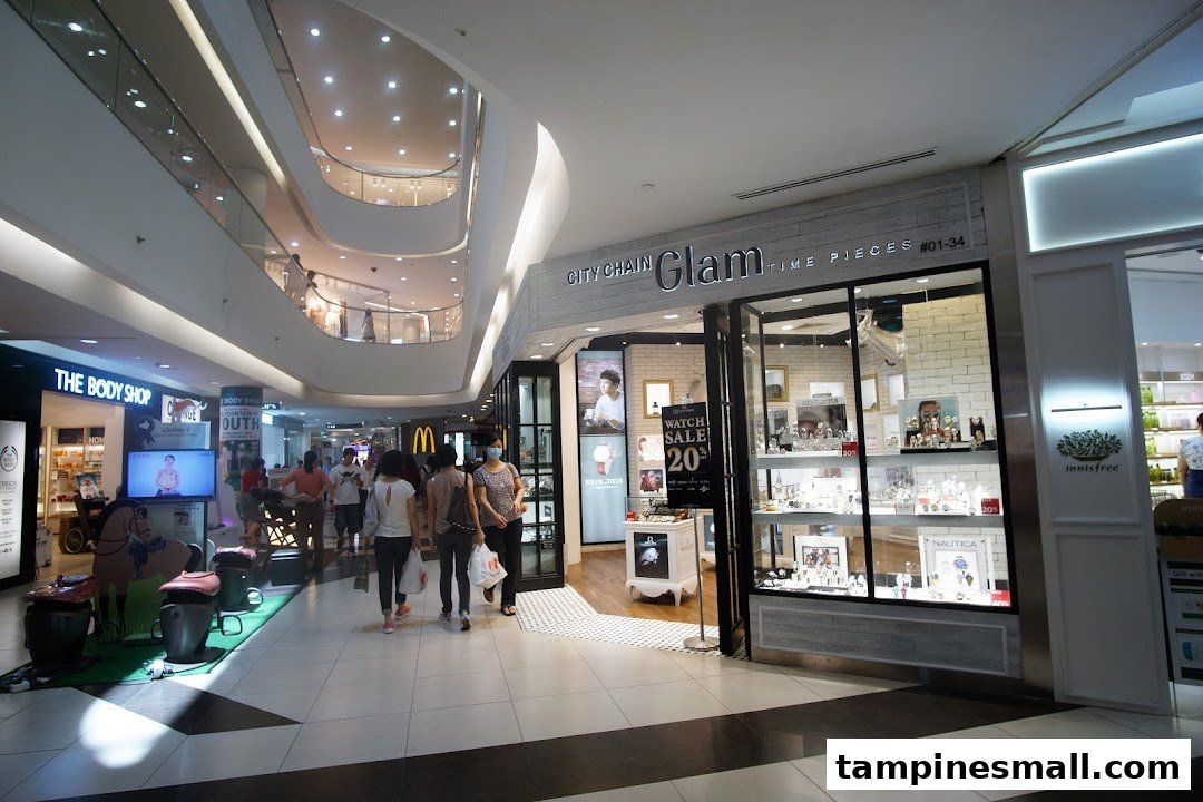 The shop front of City Chain Glam, a timepiece store, within a bustling shopping mall.