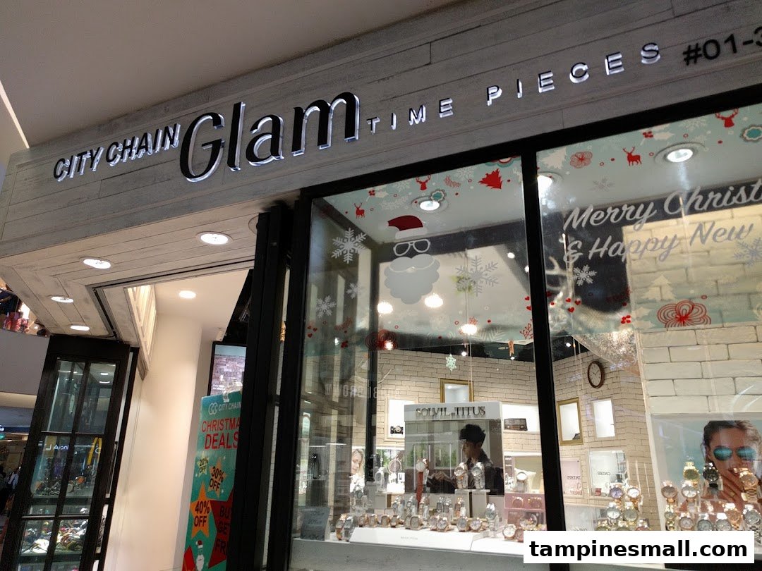 Exterior view of City Chain Glam Time Pieces shop with festive window decorations and watch displays.