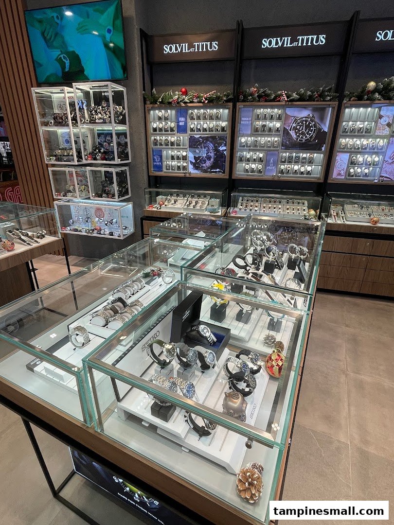 An interior view of City Chain, showcasing numerous watches in glass display cases and wall-mounted shelves.