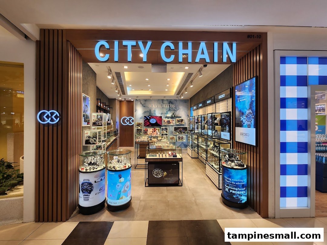 Brightly lit City Chain shop entrance showcasing a wide array of watches and eyewear in display cases.