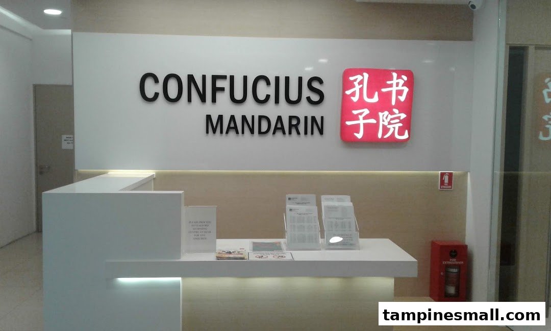 The bright and modern reception area of Confucius Mandarin, featuring a prominent logo and desk.
