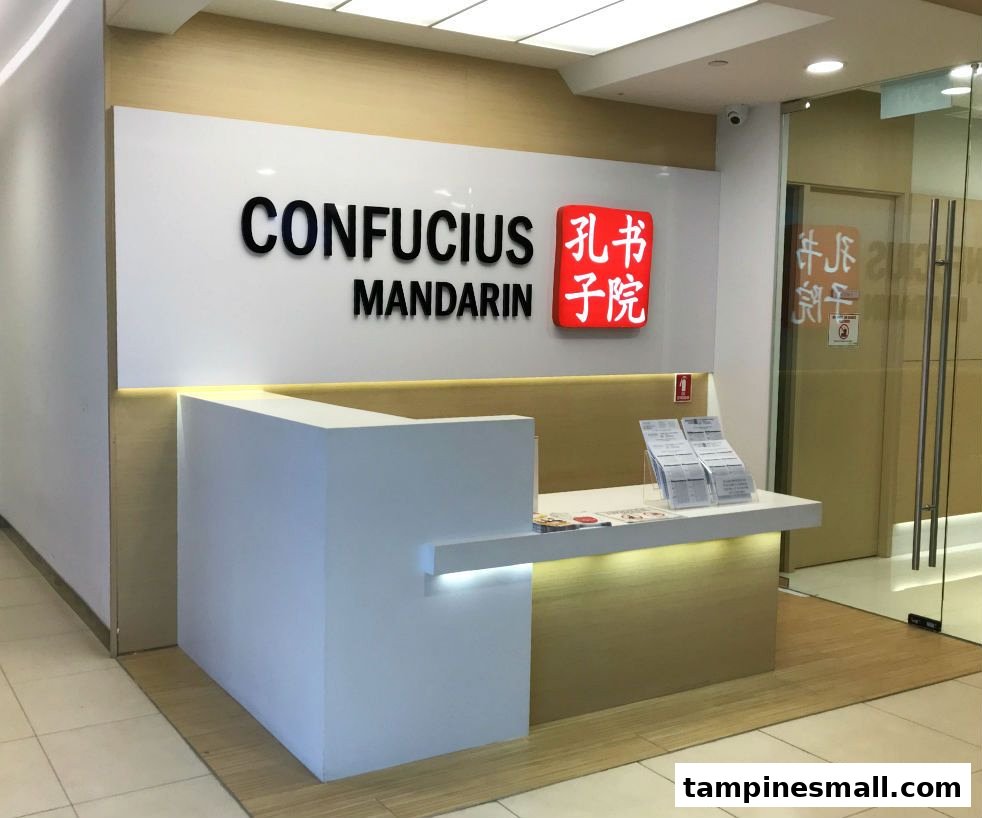 The bright, modern reception area of Confucius Mandarin, featuring a prominent logo and information desk.