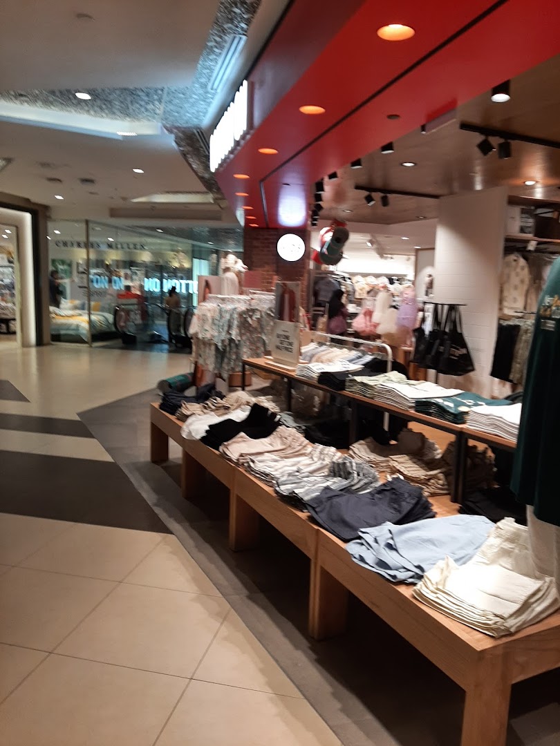 Interior view of Cotton On Tampines, showcasing a wide array of casual clothing and accessories on display.