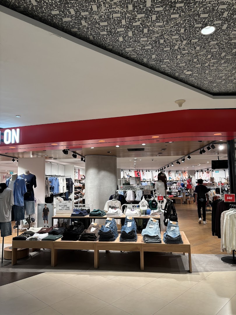 The entrance of Cotton On Tampines, showcasing trendy apparel and accessories on display.