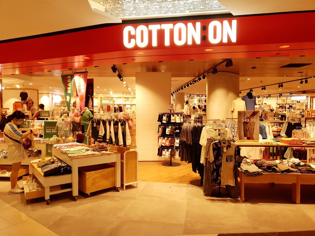 The vibrant entrance of Cotton On Tampines, showcasing trendy apparel and a welcoming shopping environment.