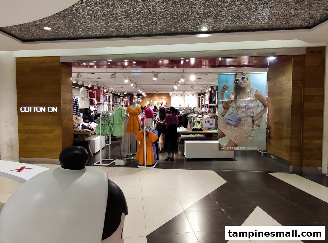 The shop front of Cotton On, showcasing its vibrant interior with clothing displays and mannequins.
