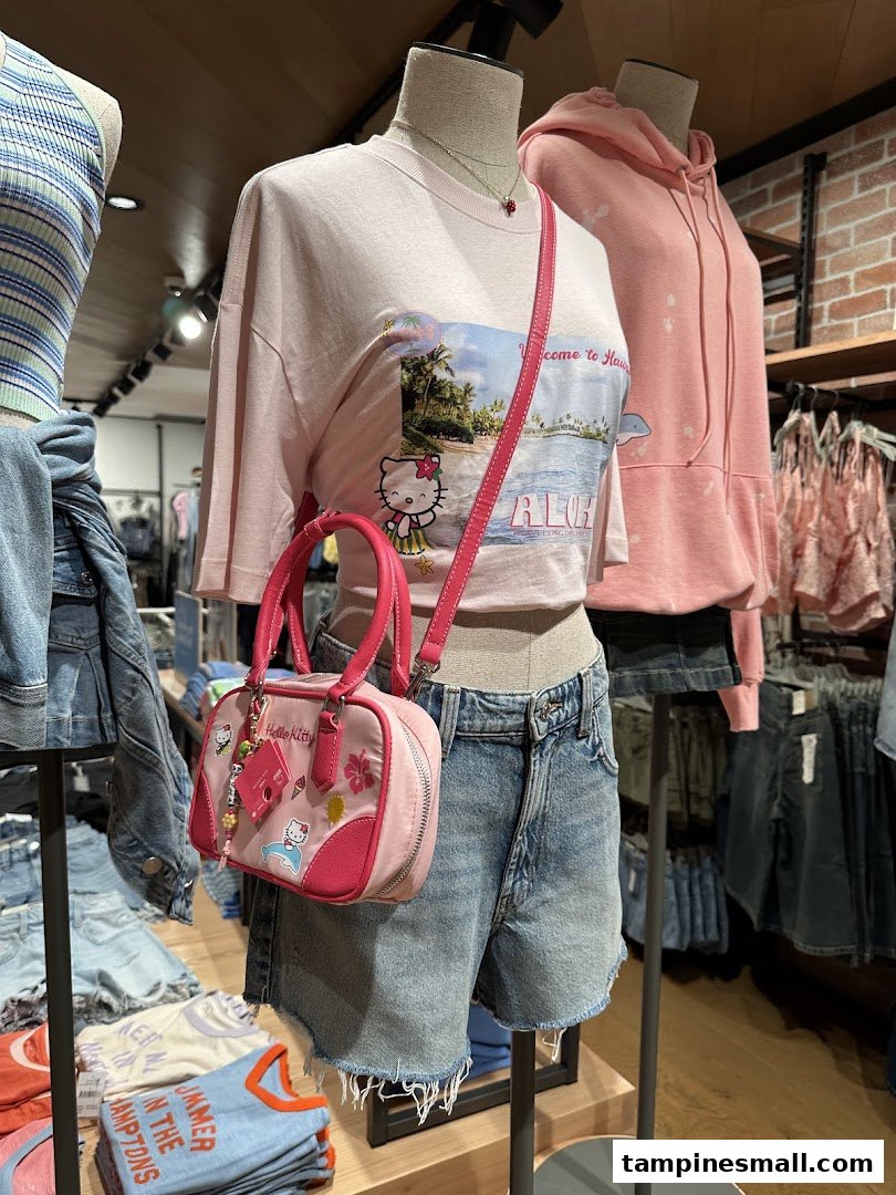Mannequins display trendy casual wear, including a Hello Kitty t-shirt and pink handbag, inside Cotton On.