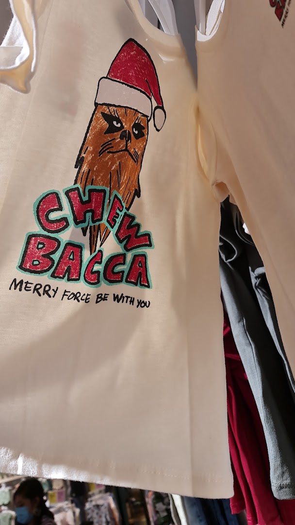 A white t-shirt featuring a festive Chewbacca design with 'CHEWBACCA MERRY FORCE BE WITH YOU' text.