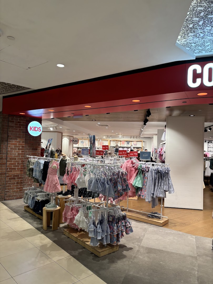 The vibrant entrance of Cotton On Tampines showcasing a wide array of kids' apparel and accessories.