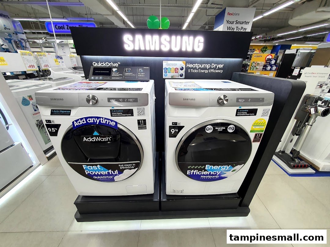 A display of Samsung washing machines and a heat pump dryer inside COURTS Tampines Mall.