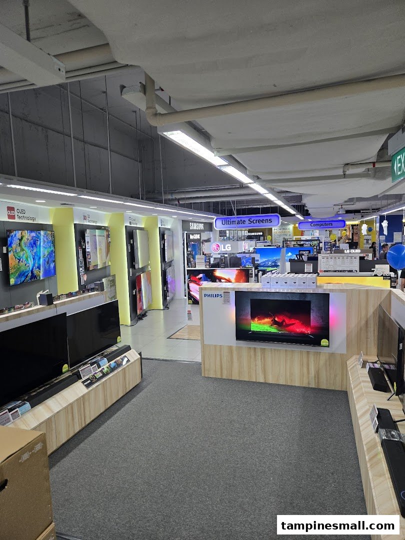 Interior view of COURTS electronics store showcasing a wide array of TVs and computer displays.