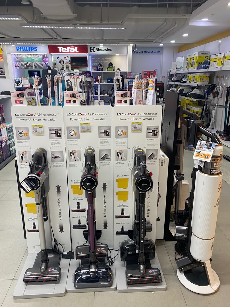 Interior of COURTS store displaying LG CordZero vacuum cleaners and various home appliances.
