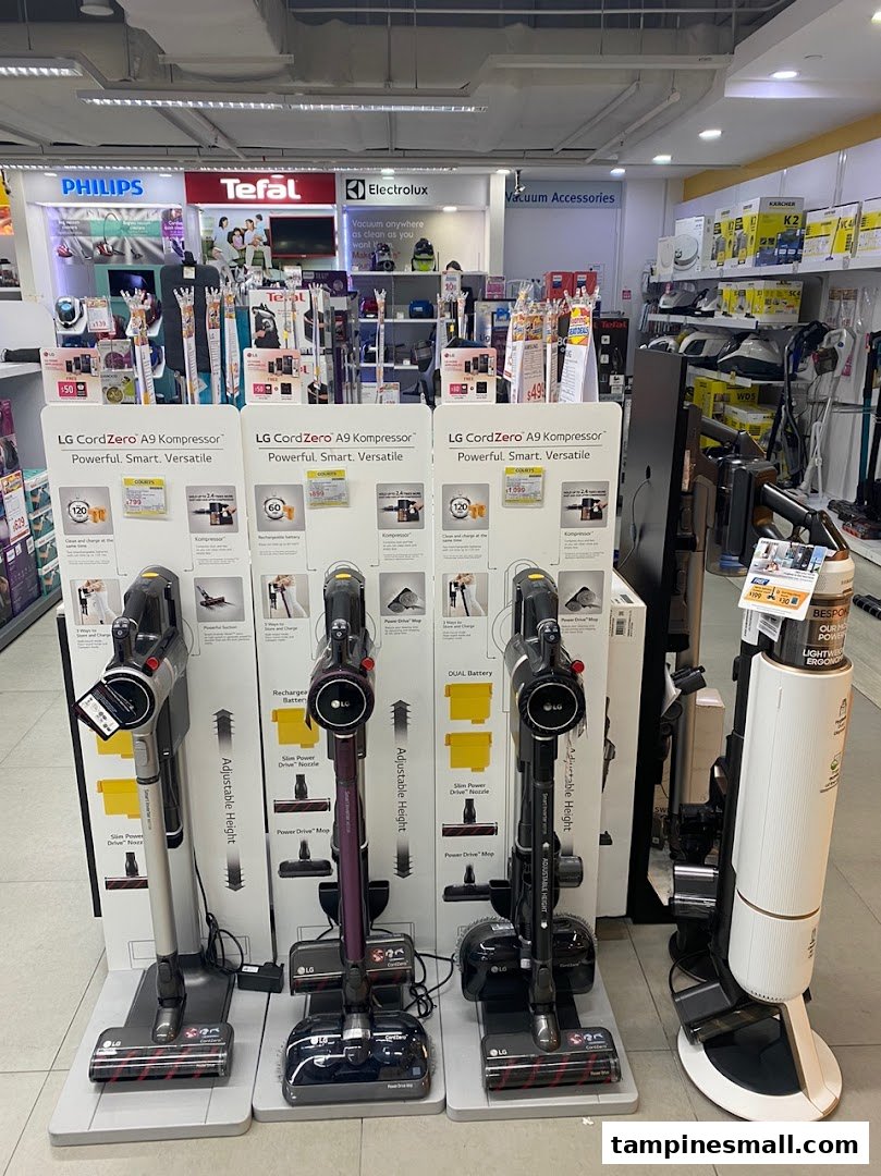 Interior of COURTS store displaying LG CordZero vacuum cleaners and various home appliances.