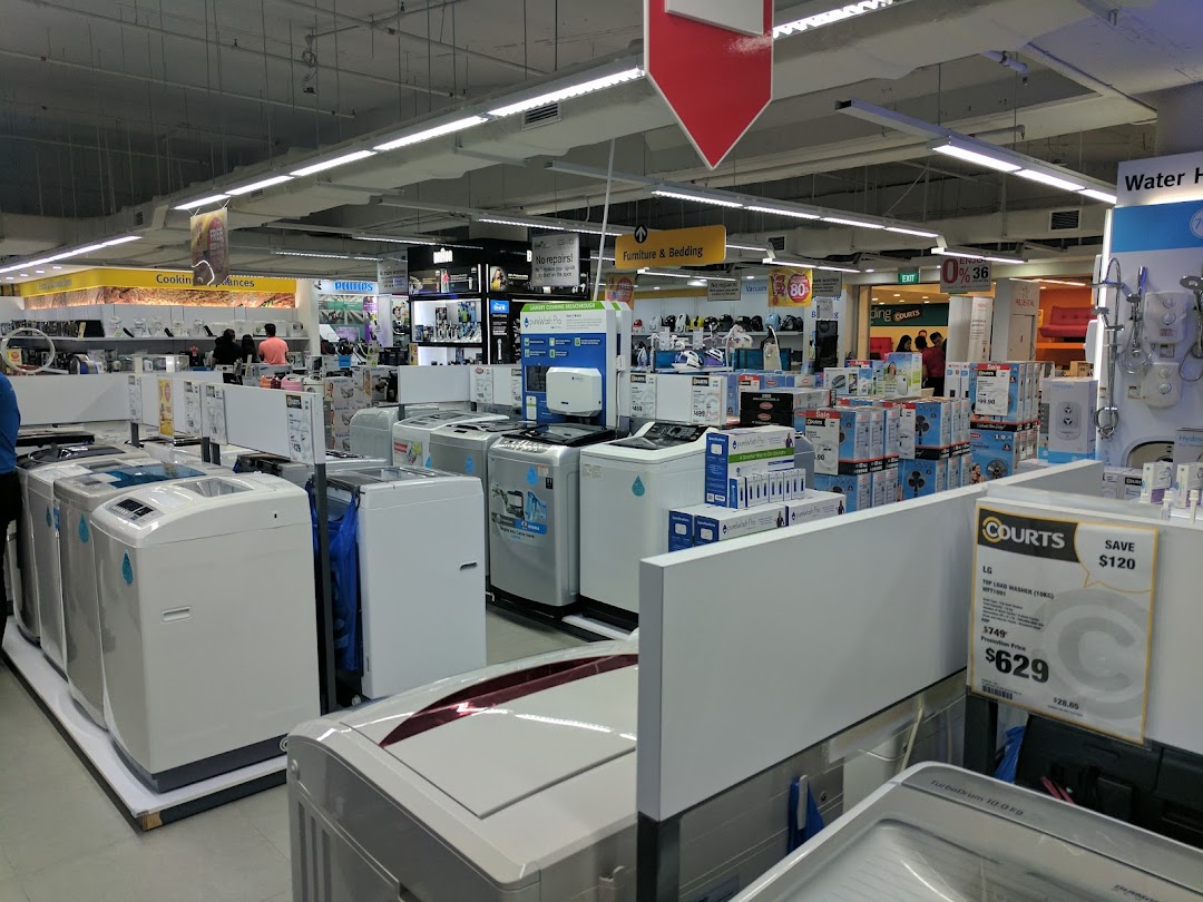 An interior view of COURTS, showcasing a wide array of home appliances like washing machines and electronics.