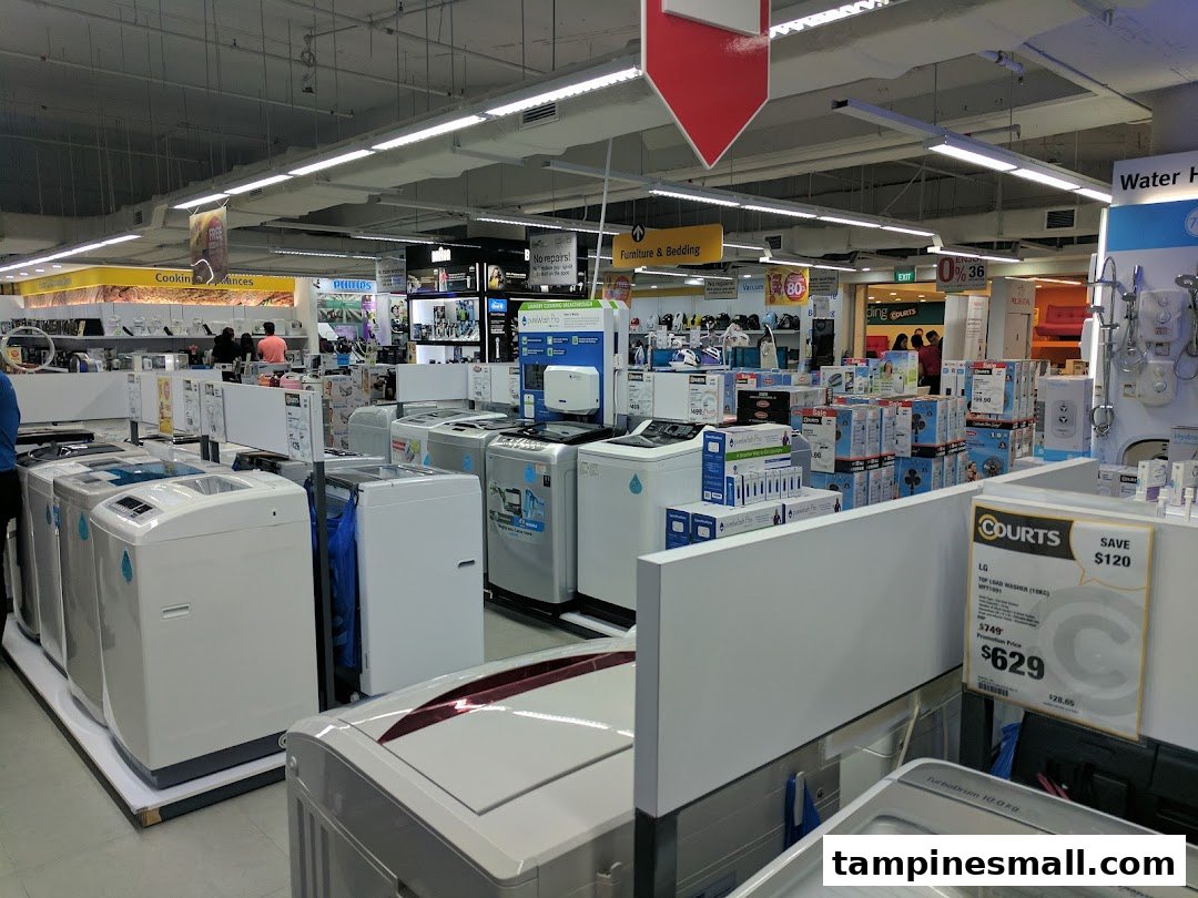 An interior view of COURTS, showcasing a wide array of home appliances like washing machines and electronics.