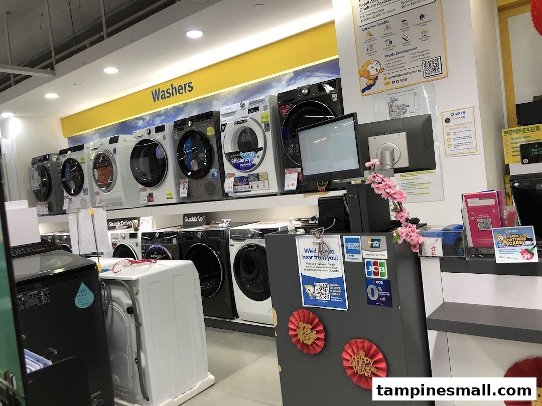 Interior view of COURTS showcasing a wide range of washing machines and a customer service counter.