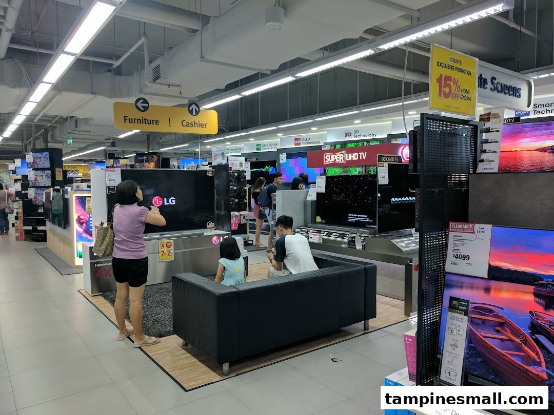 Customers browse a wide selection of televisions and electronics at COURTS Tampines Mall.