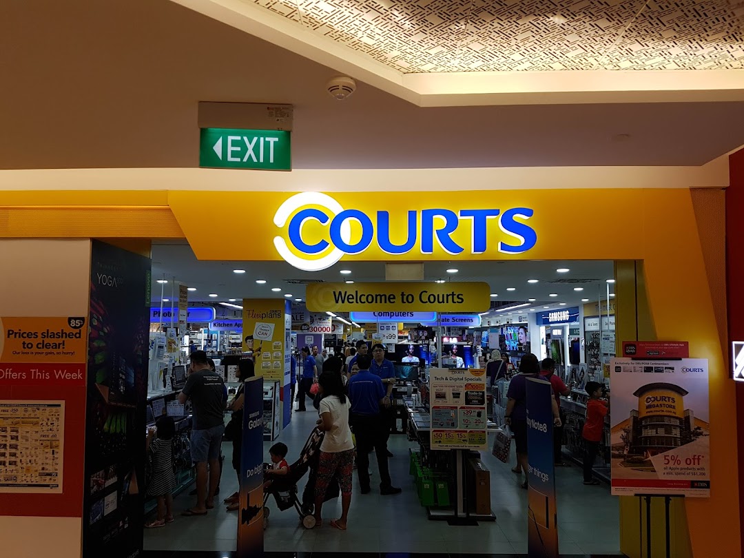 The vibrant entrance of COURTS Tampines Mall, showcasing electronics and home appliances, bustling with shoppers.