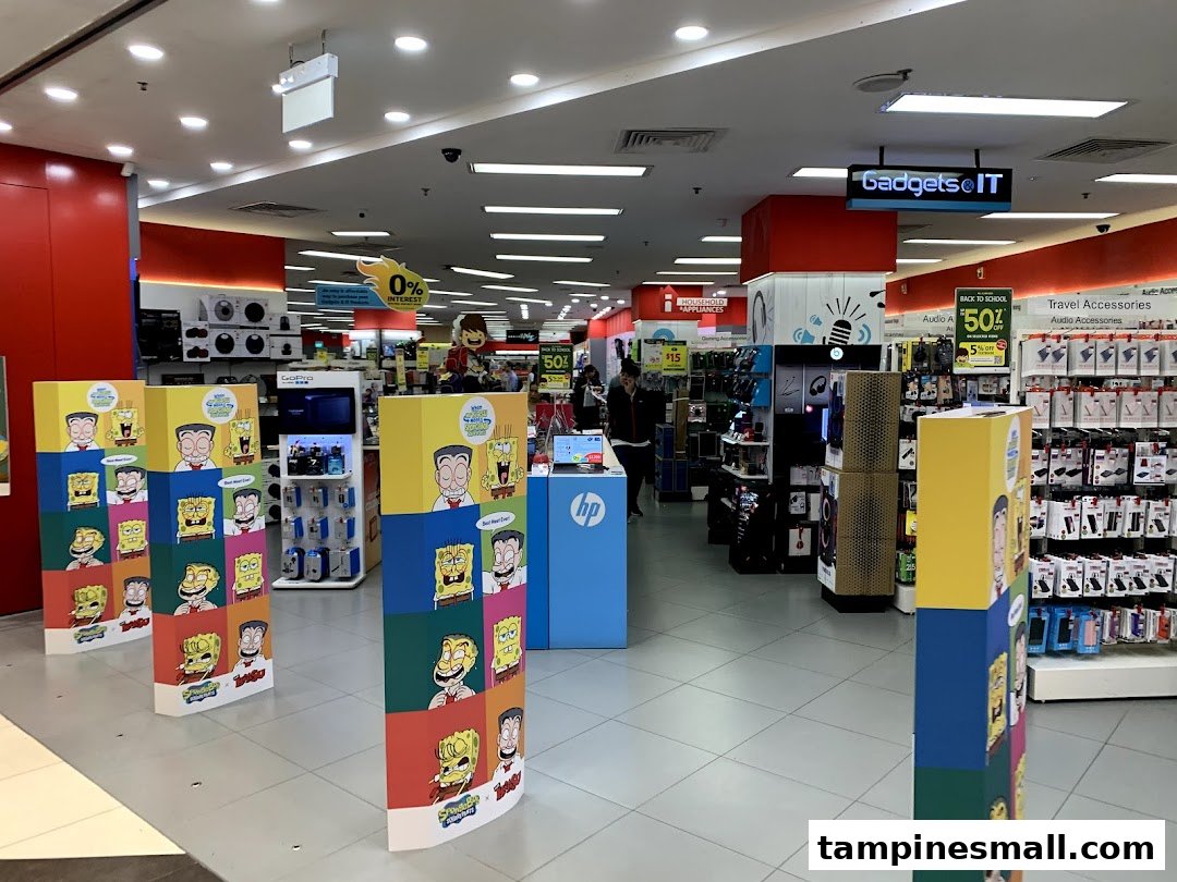 An interior view of COURTS Tampines Mall, showcasing various electronics, gadgets, and accessories sections.