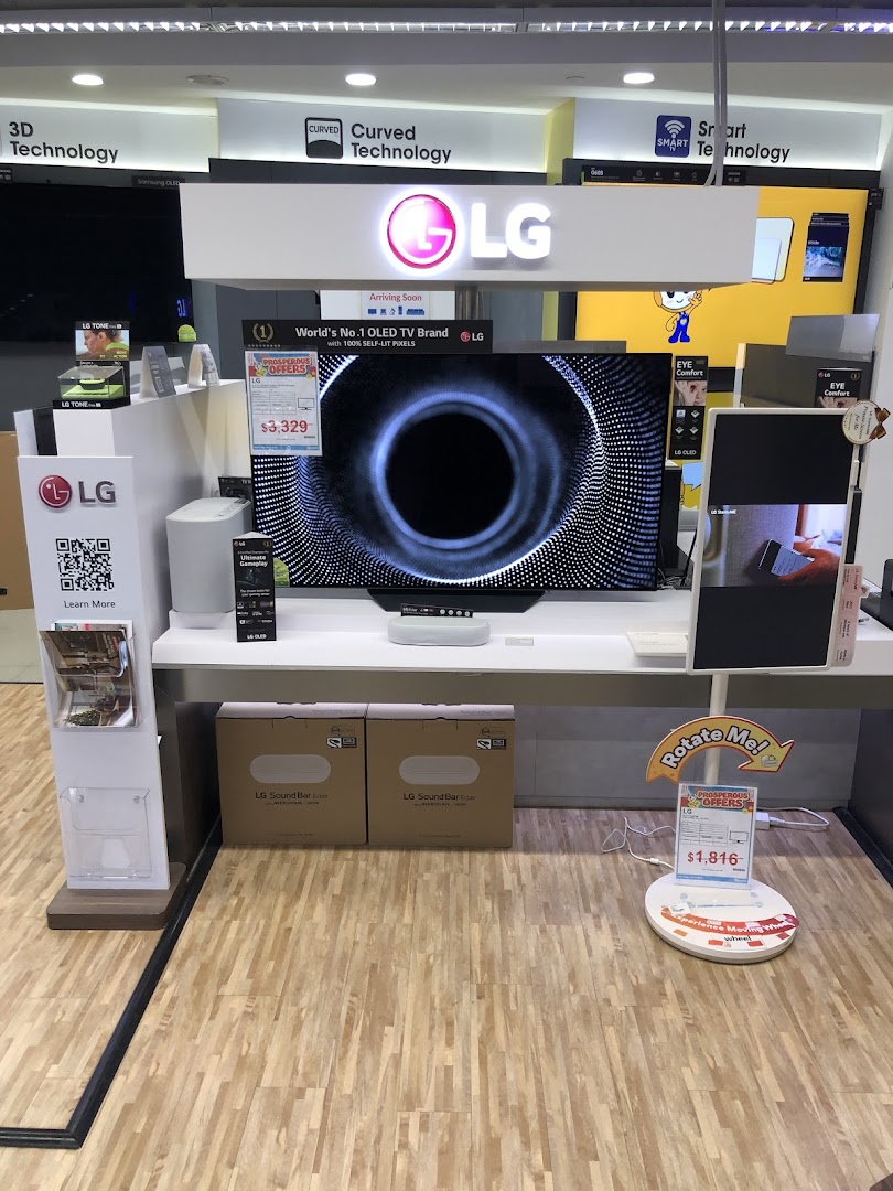 An in-store display at COURTS featuring LG OLED TVs, soundbars, and other home entertainment technology.