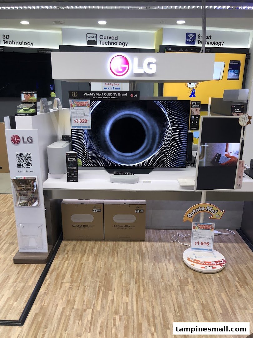 An in-store display at COURTS featuring LG OLED TVs, soundbars, and other home entertainment technology.