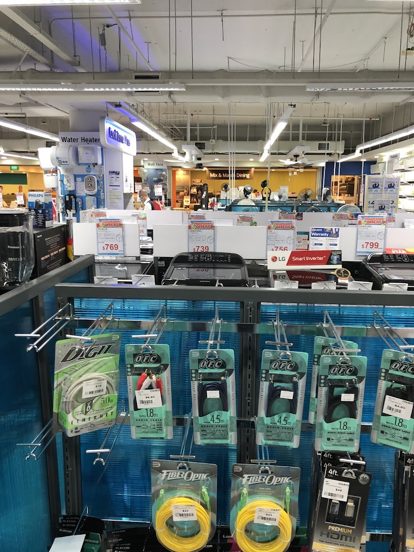 An interior view of COURTS Tampines Mall, showcasing various home appliances, electronics, and cables.