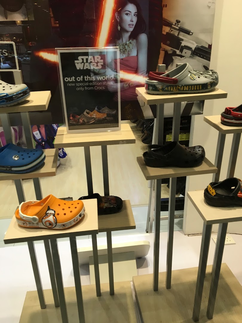A retail display showcasing various Crocs shoes, including special Star Wars edition designs.