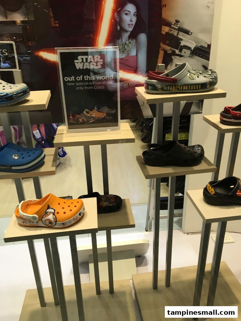 A retail display showcasing various Crocs shoes, including special Star Wars edition designs.