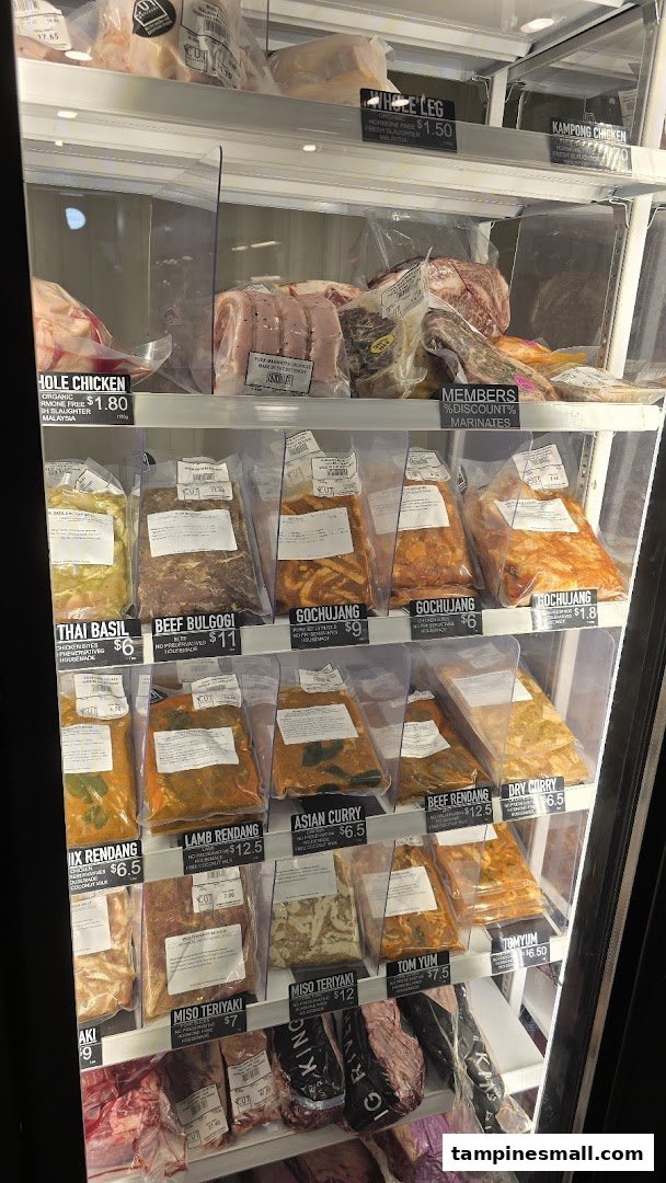 A refrigerated display case showcasing various packaged meats, marinated cuts, and their prices at Cut Butchery.