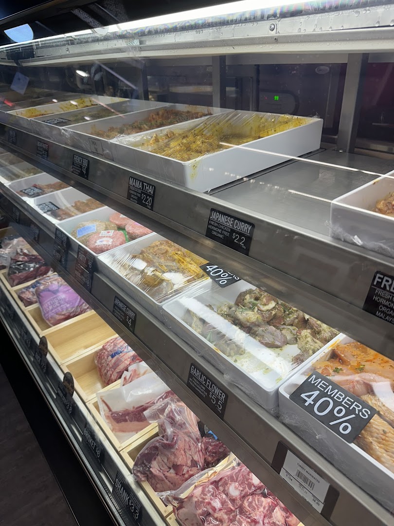 A display fridge at Cut Butchery showcasing fresh meats, marinated cuts, and prepared items.