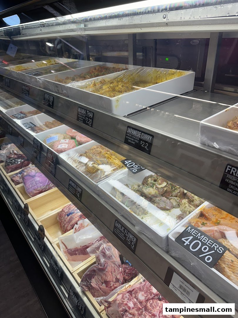 A display fridge at Cut Butchery showcasing fresh meats, marinated cuts, and prepared items.