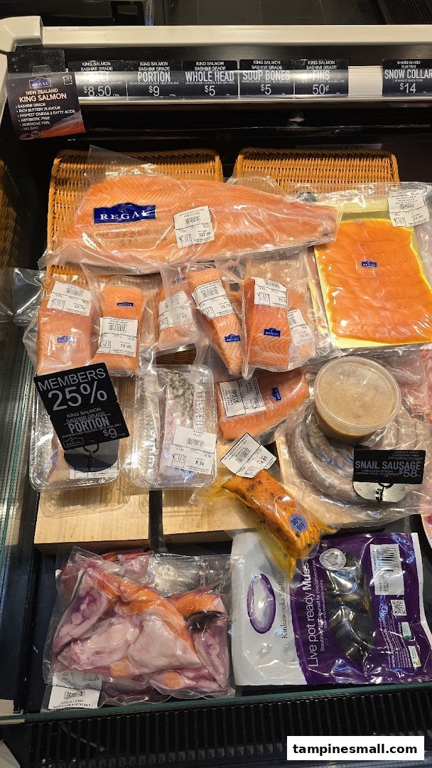 A refrigerated display case showcasing packaged fresh salmon, seafood, and specialty meats at Cut Butchery.