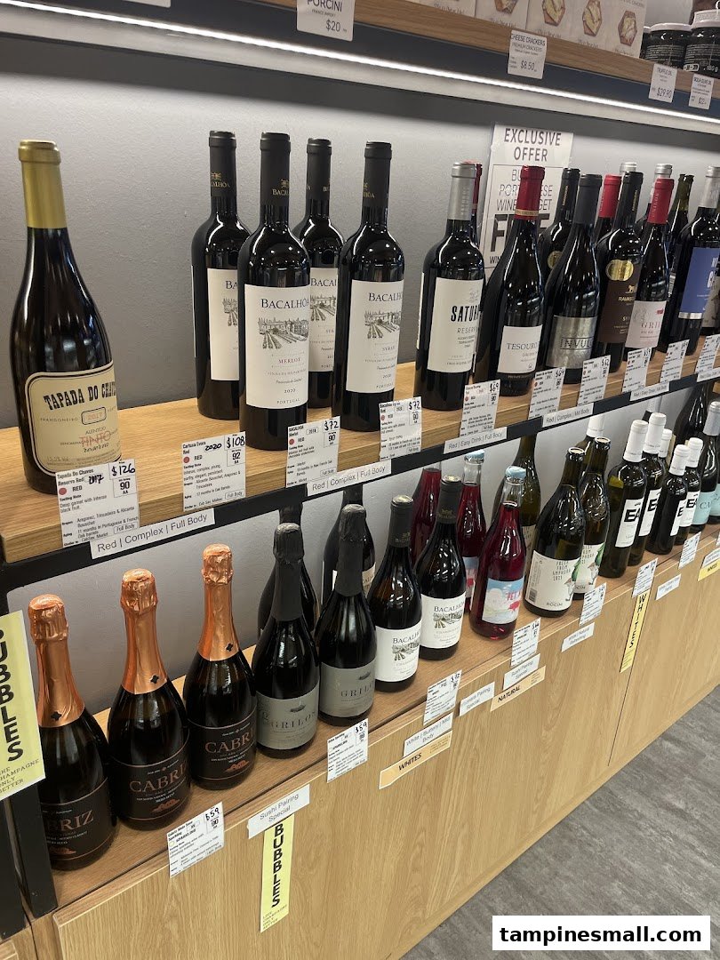 A wide selection of wine and sparkling beverages displayed on wooden shelves in a retail store.