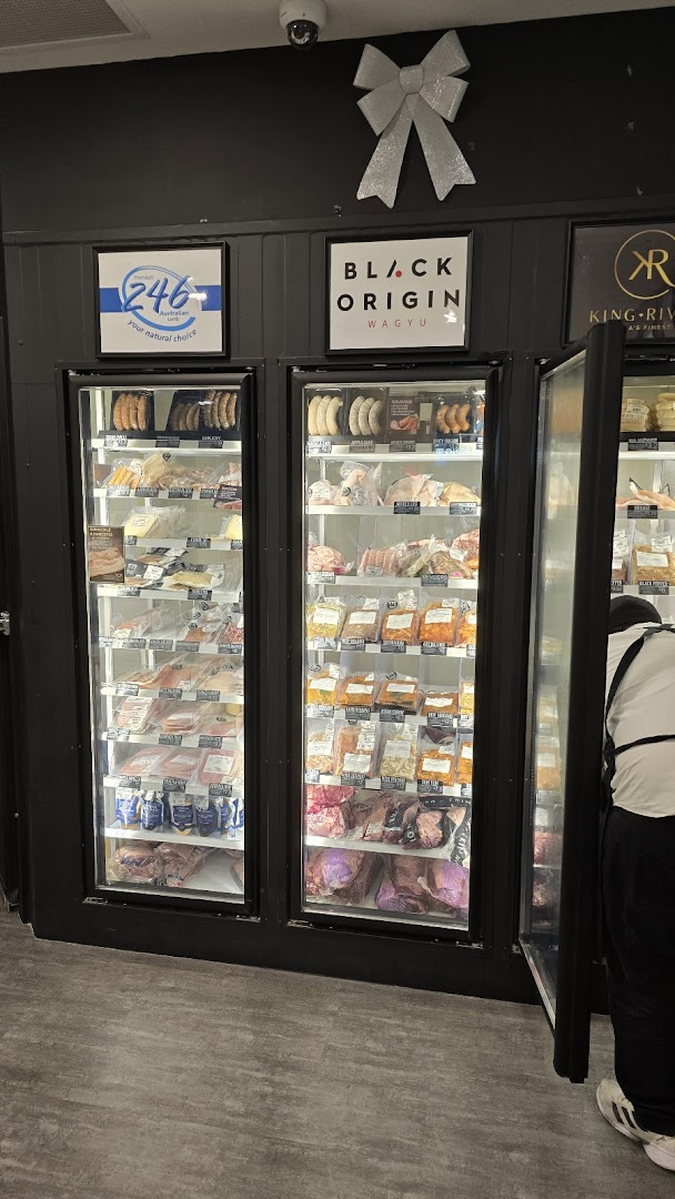 Inside Cut Butchery, showcasing refrigerated displays filled with various packaged meats and sausages.