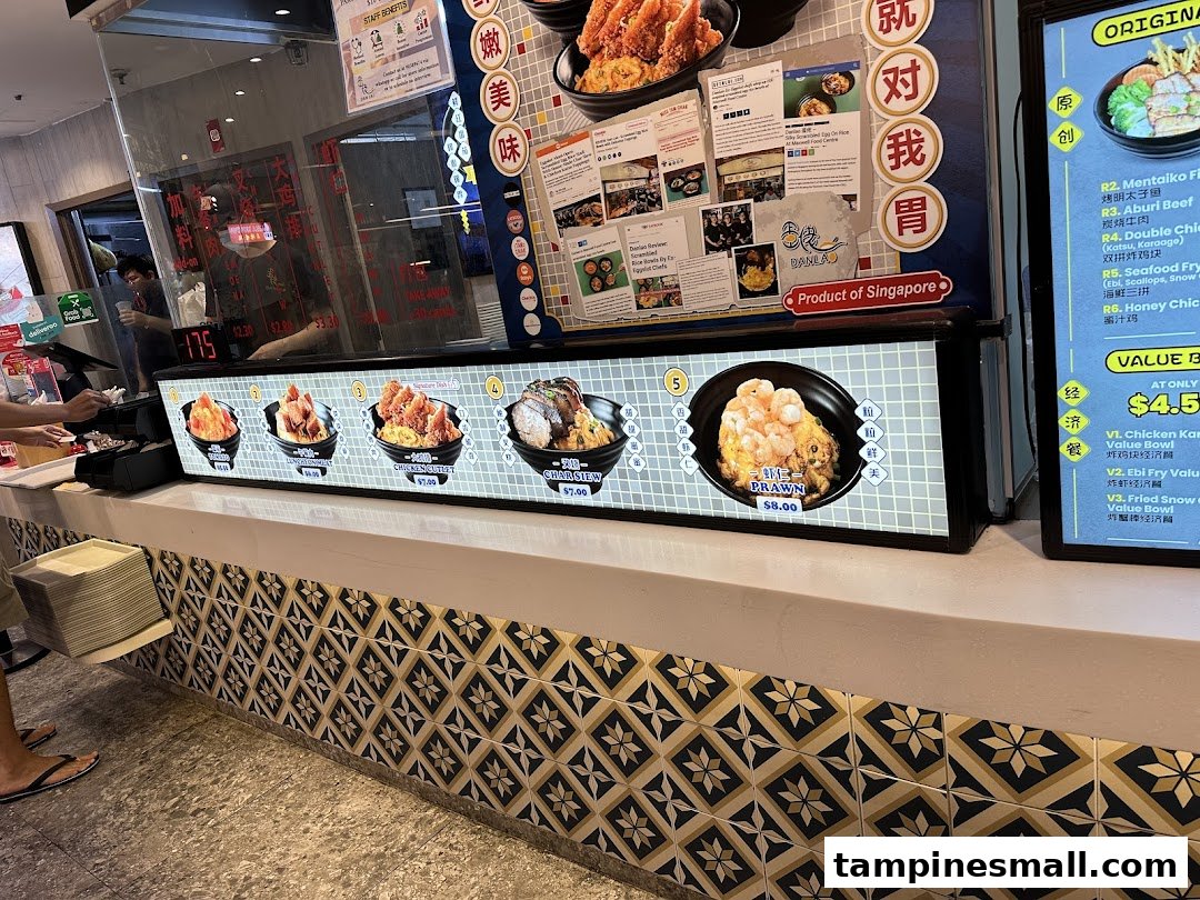 A vibrant counter view at Dan Lao, showcasing delicious scrambled egg rice dishes and menu options.